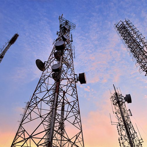 Telecommunications pylons against a blue/pink sky